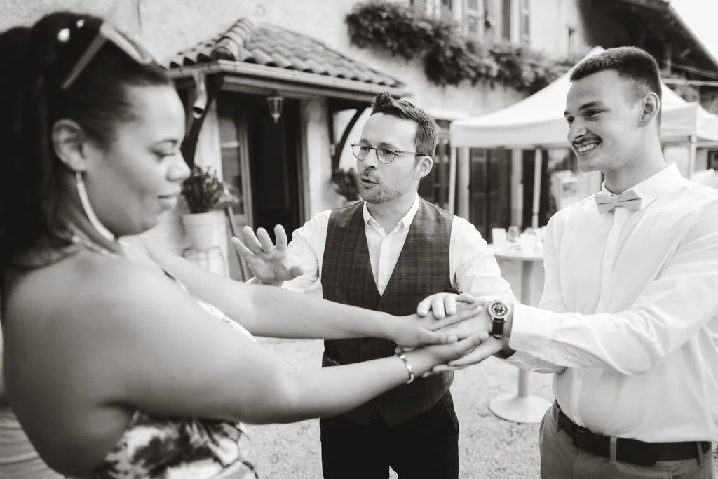 Wedding guests taking part in a mentalism effect with Hugo Marceau during a drinks reception